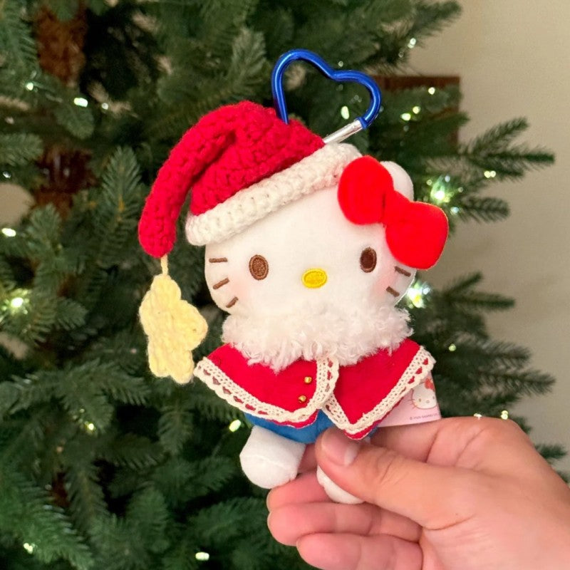 Hello Kitty Christmas plush bag charm wearing red cape and knit Santa hat
